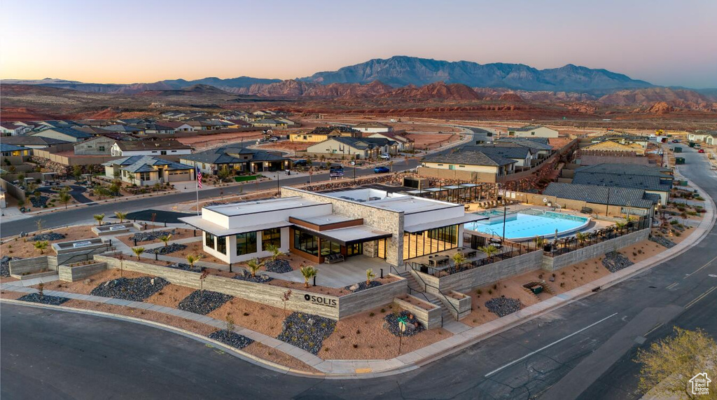 Aerial view at dusk of a mountain view, a residential view, and view of pool area