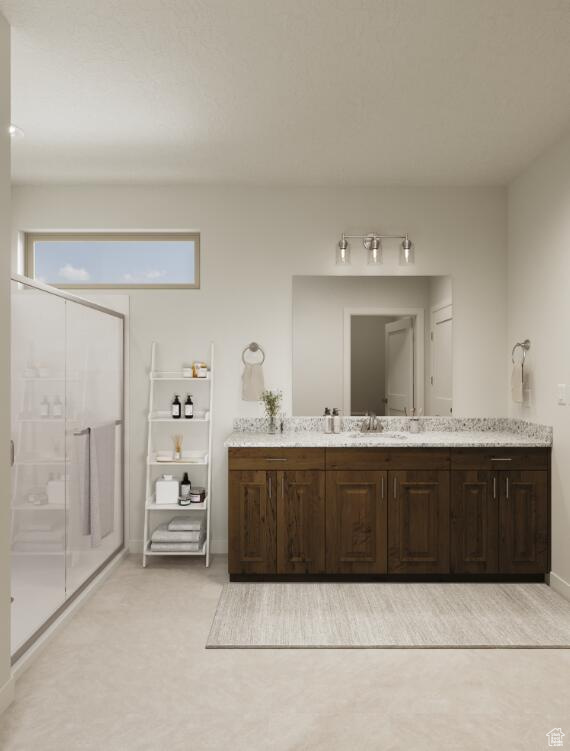 Bathroom with double vanity, a shower stall, and baseboards