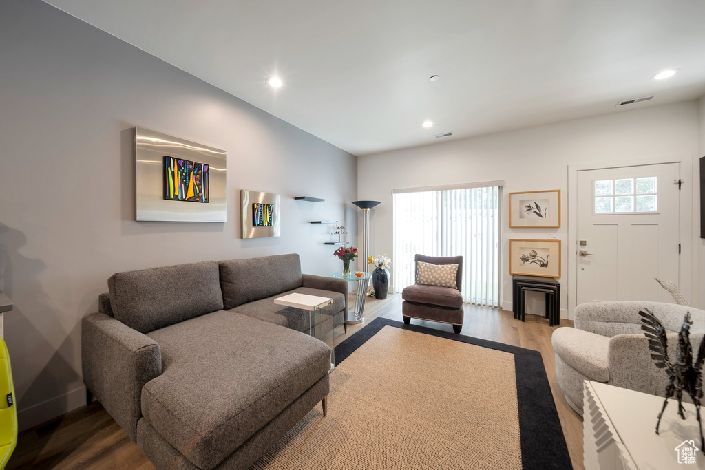 Living area with wood finished floors and recessed lighting