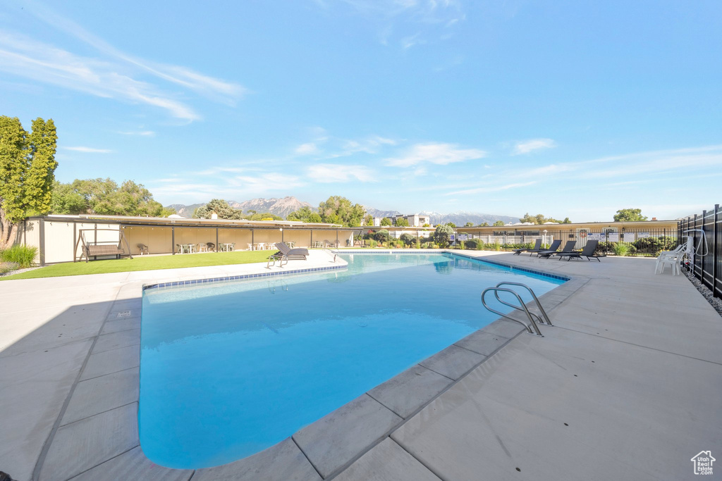 View of swimming pool with a mountain view and a patio area