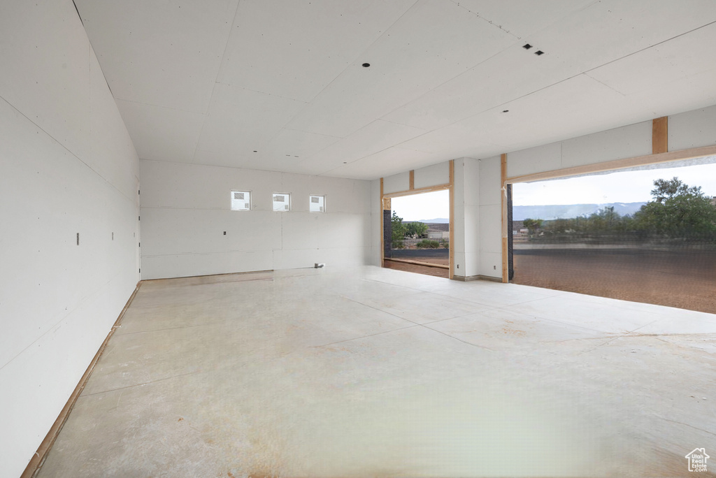 Unfurnished room featuring concrete flooring
