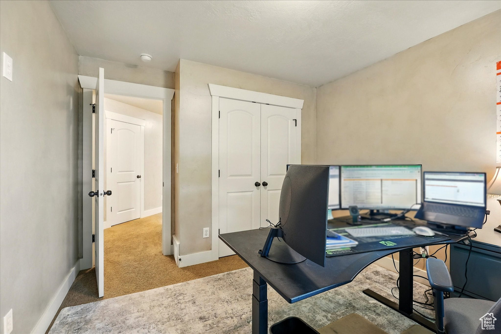 Home office with carpet and baseboards