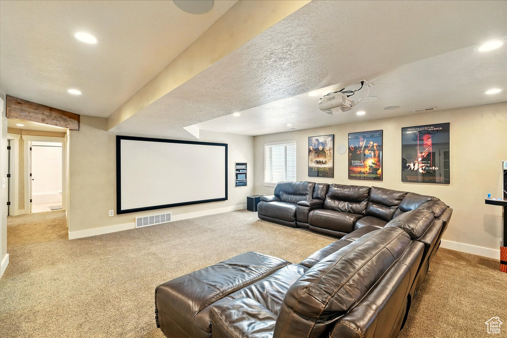 Home theater featuring carpet, baseboards, and recessed lighting