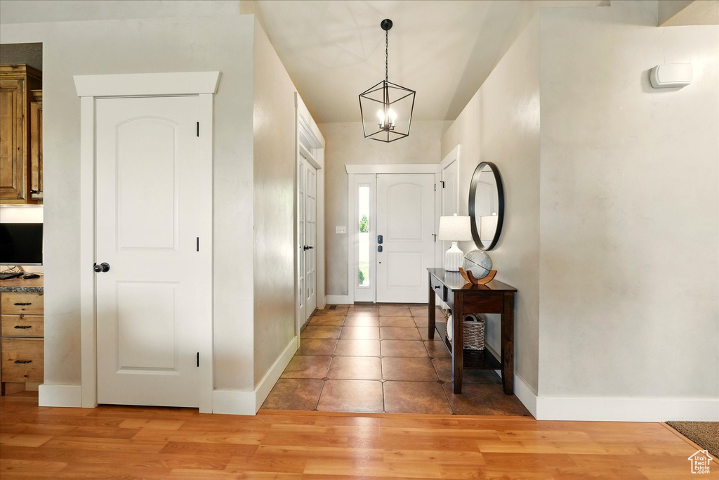 Entrance foyer featuring baseboards and light wood-style floors