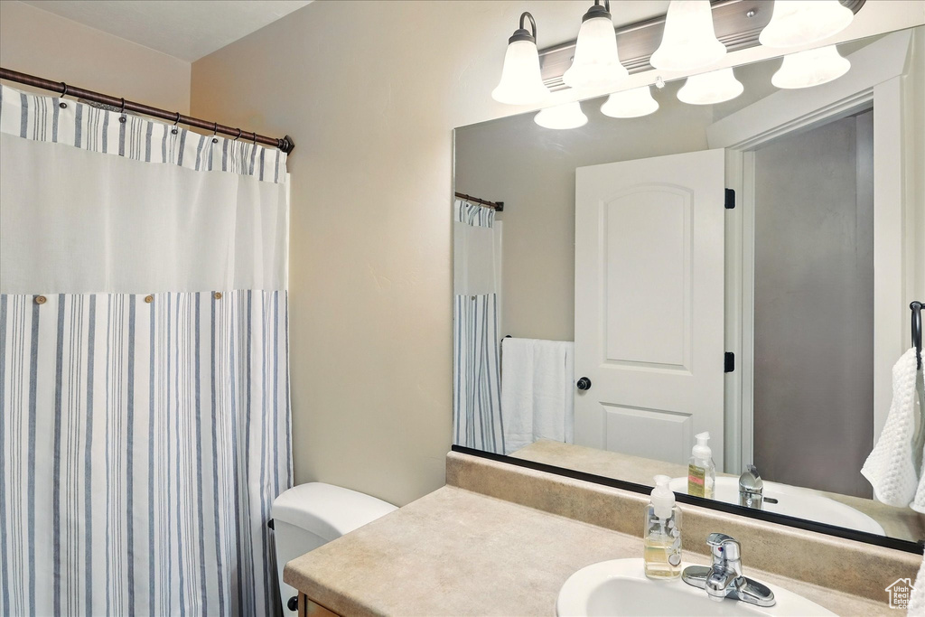 Full bath featuring vanity and toilet