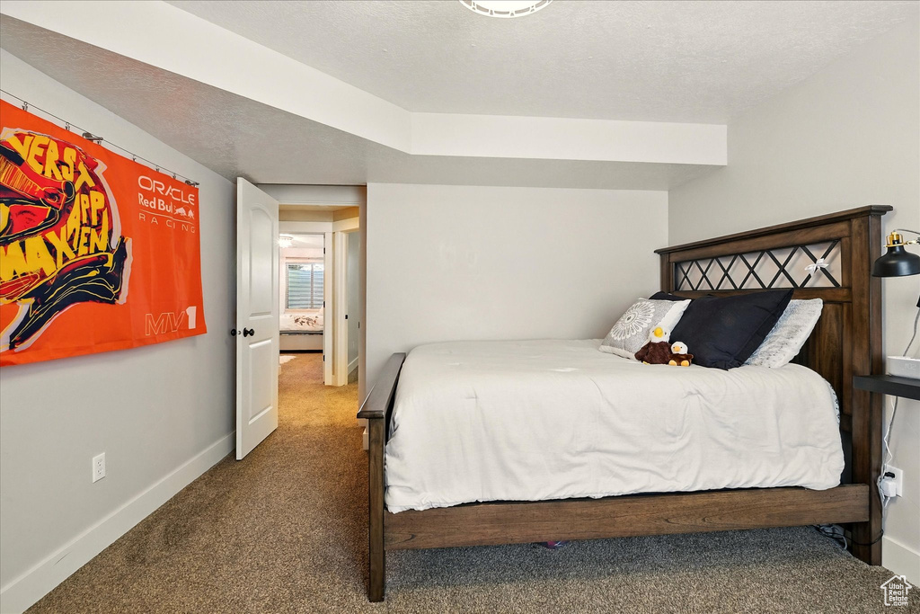Bedroom featuring carpet floors and baseboards