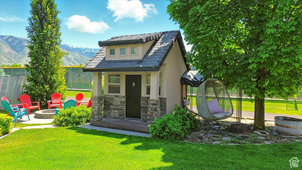 View of outbuilding featuring an outdoor fire pit and a mountain view