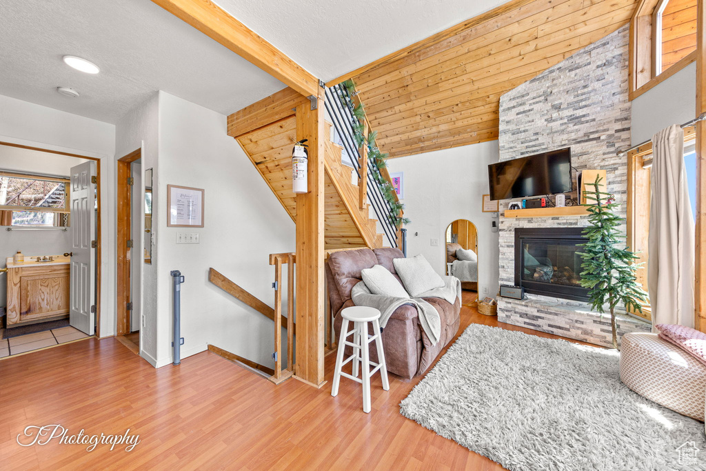 Living area featuring wood finished floors, a fireplace, and baseboards
