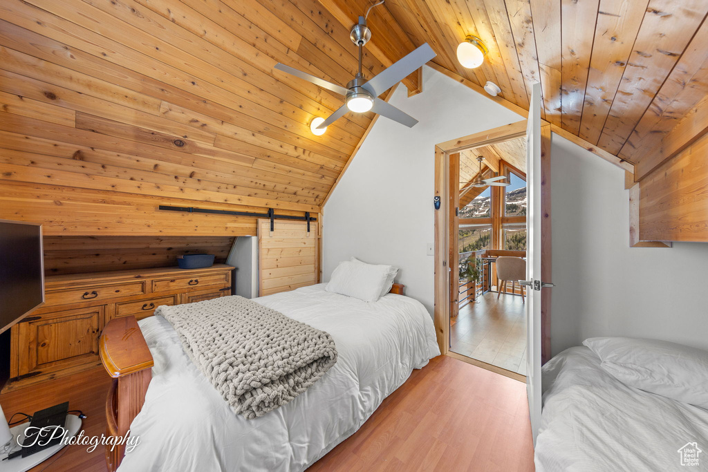 Bedroom with wooden ceiling, lofted ceiling, and wood finished floors