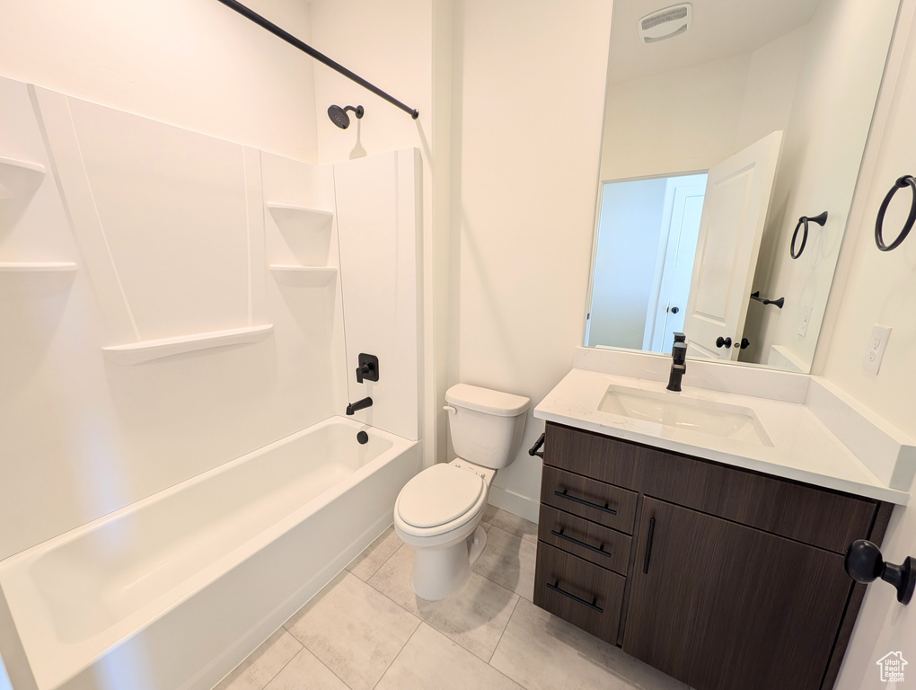 Full bath featuring vanity, toilet, shower / bathtub combination, and tile patterned flooring