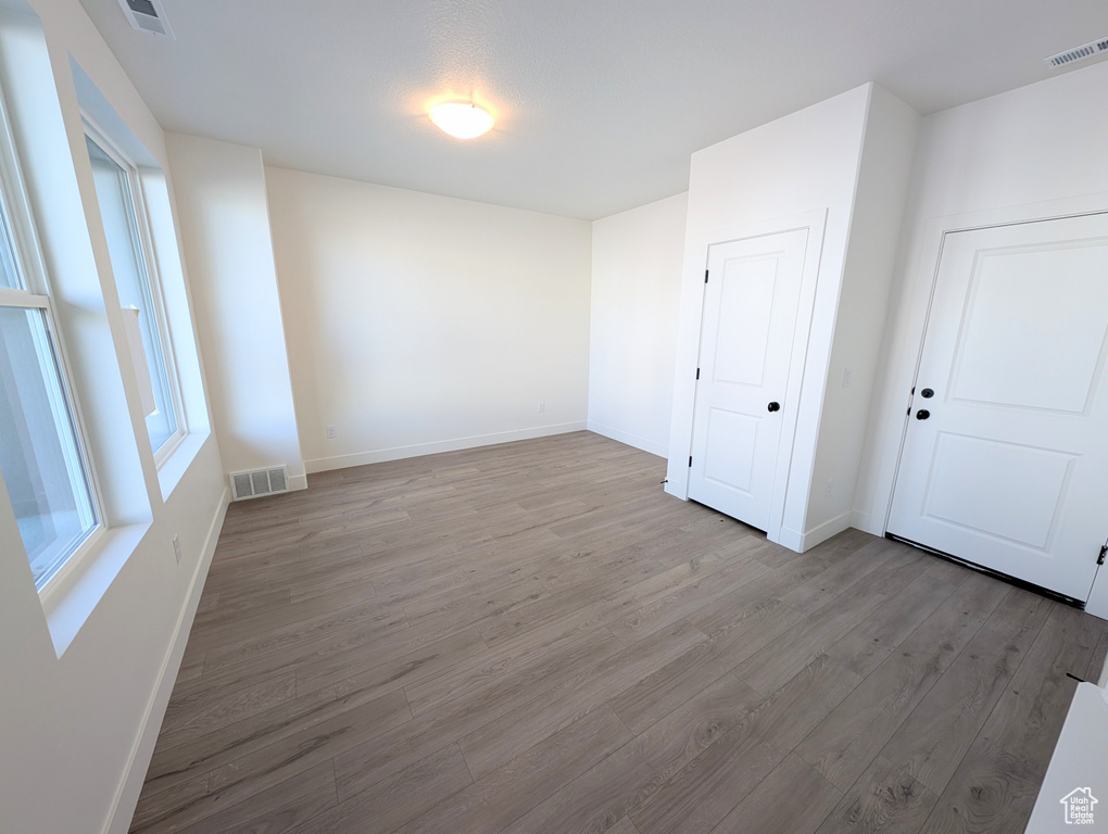 Spare room featuring wood finished floors and baseboards