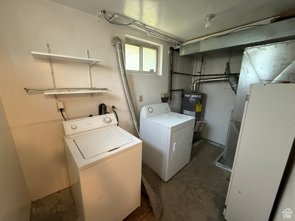 Washroom featuring separate washer and dryer and electric water heater