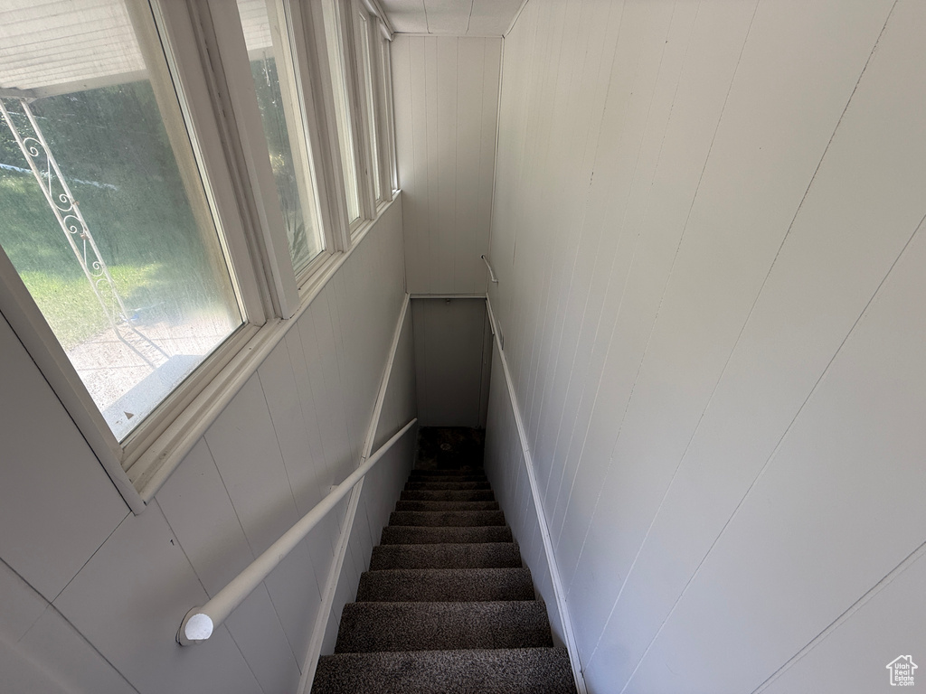 Stairs featuring a decorative wall