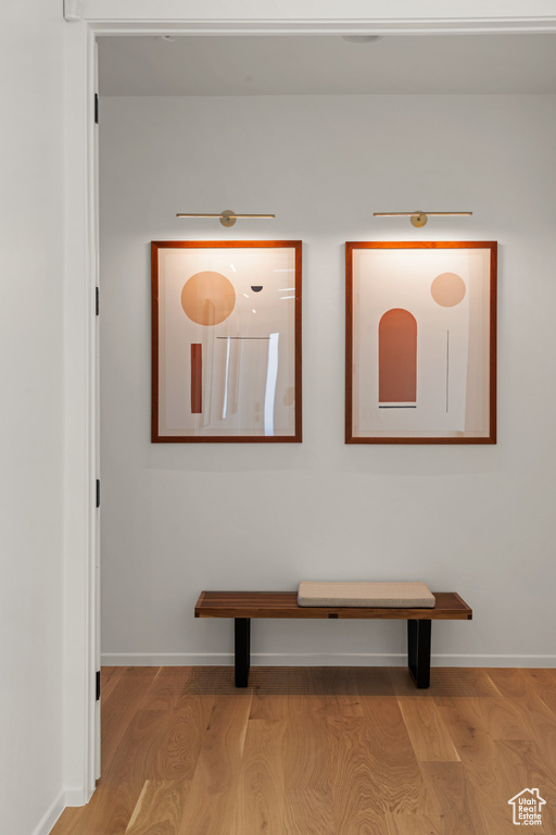 Corridor with wood finished floors and baseboards