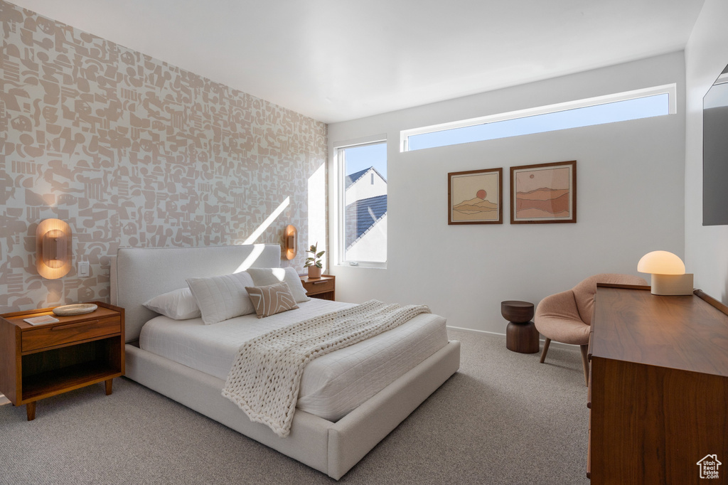 Bedroom featuring wallpapered walls, multiple windows, carpet floors, and baseboards