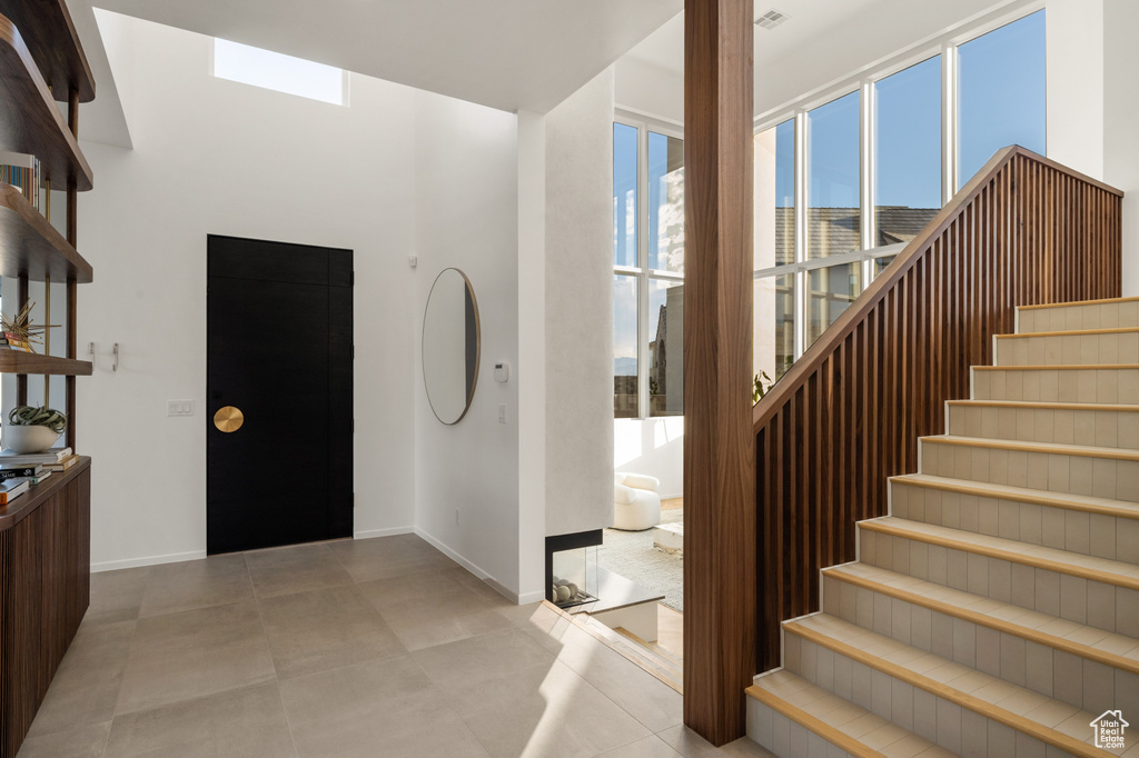 Entrance foyer with stairs and baseboards