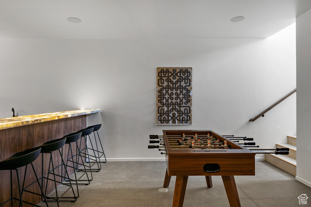 Rec room featuring baseboards and bar area