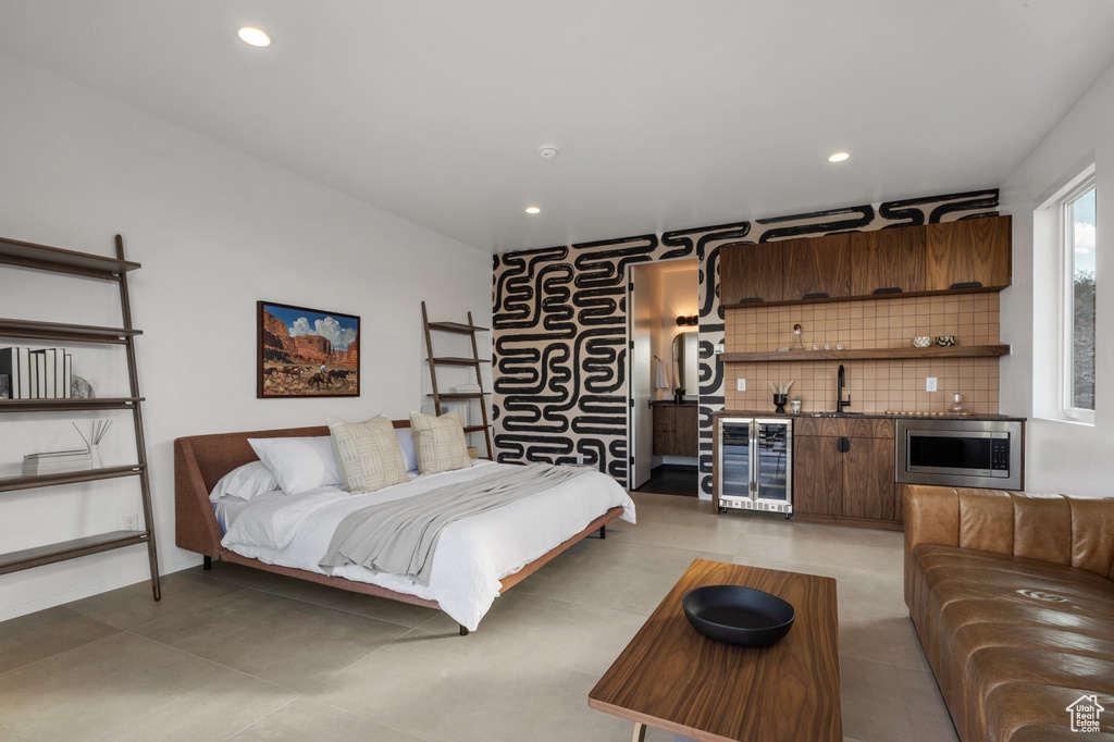 Bedroom with beverage cooler, wet bar, and recessed lighting