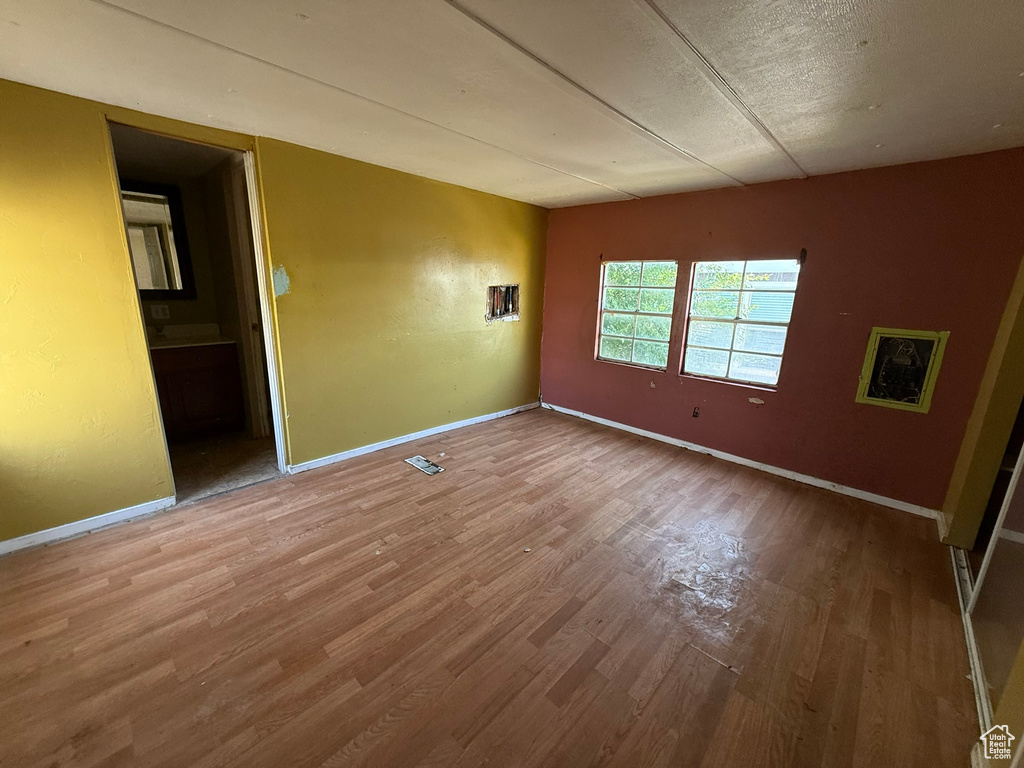Unfurnished room featuring wood finished floors and baseboards