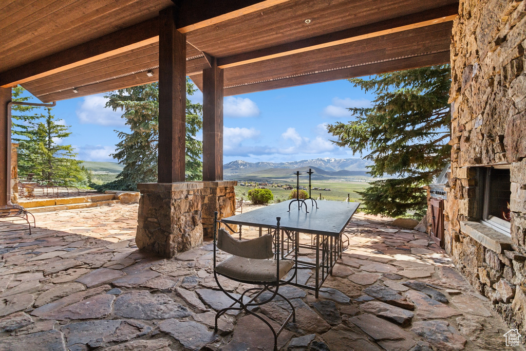 View of patio / terrace featuring a mountain view and outdoor dining area