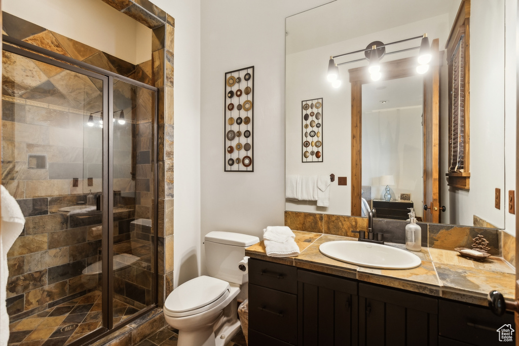 Bathroom with vanity, toilet, a stall shower, and ensuite bath