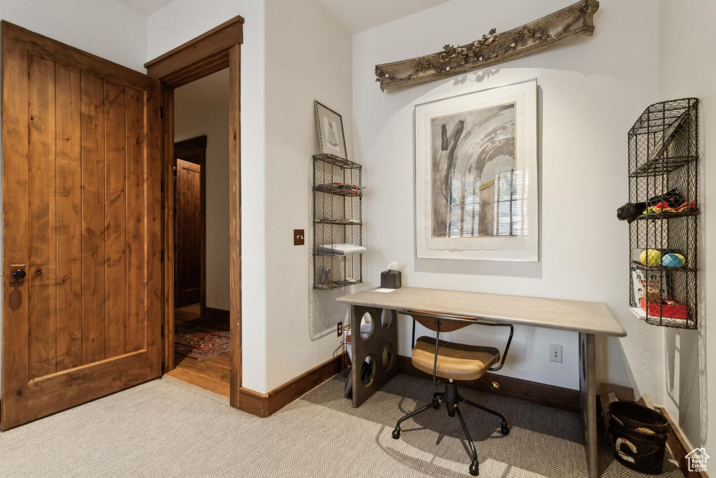 Home office featuring carpet floors and baseboards
