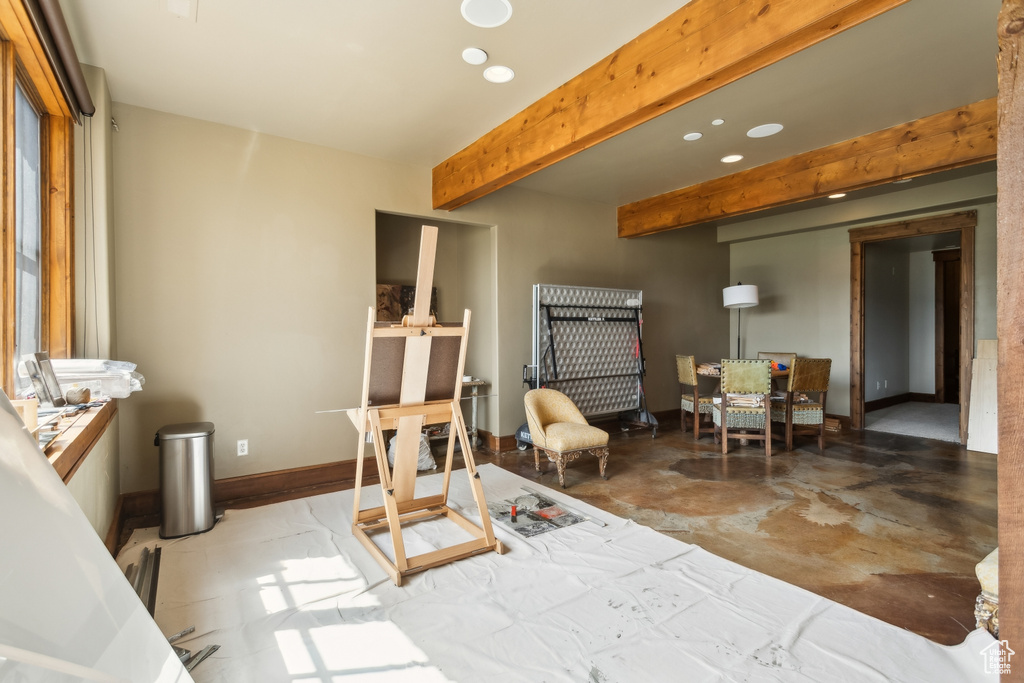 Interior space with beam ceiling, recessed lighting, concrete flooring, and baseboards