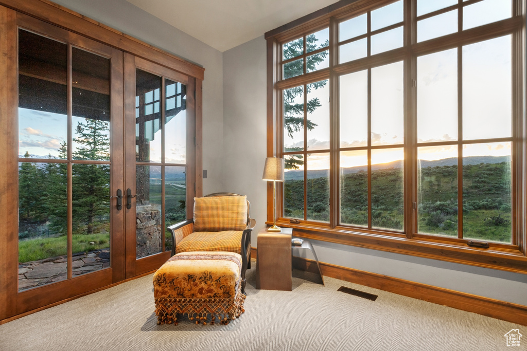 Sitting room featuring french doors and baseboards