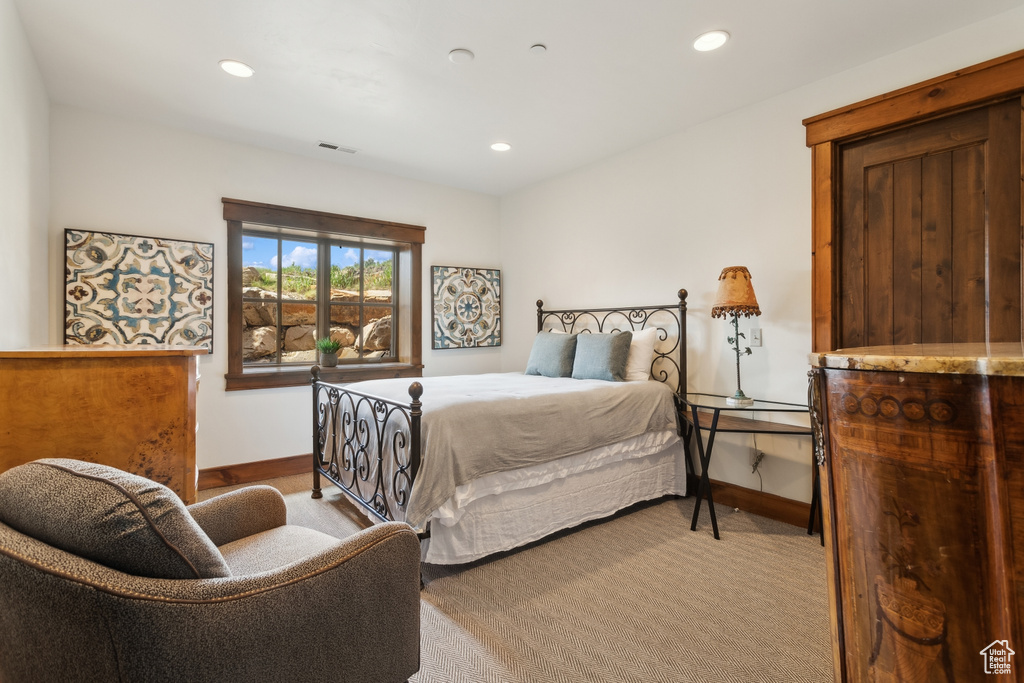 Carpeted bedroom with baseboards and recessed lighting