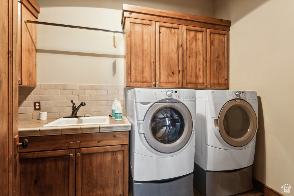 Laundry area featuring cabinet space and washing machine and clothes dryer