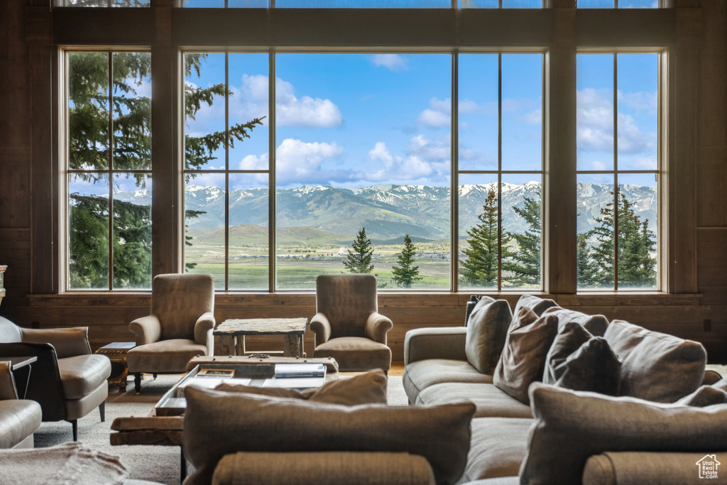 Living area featuring wooden walls and a mountain view