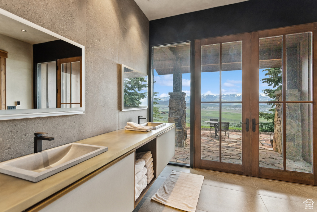 Entryway with a sink, french doors, and light tile patterned flooring