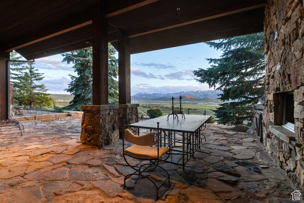 View of patio / terrace featuring a mountain view and outdoor dining area