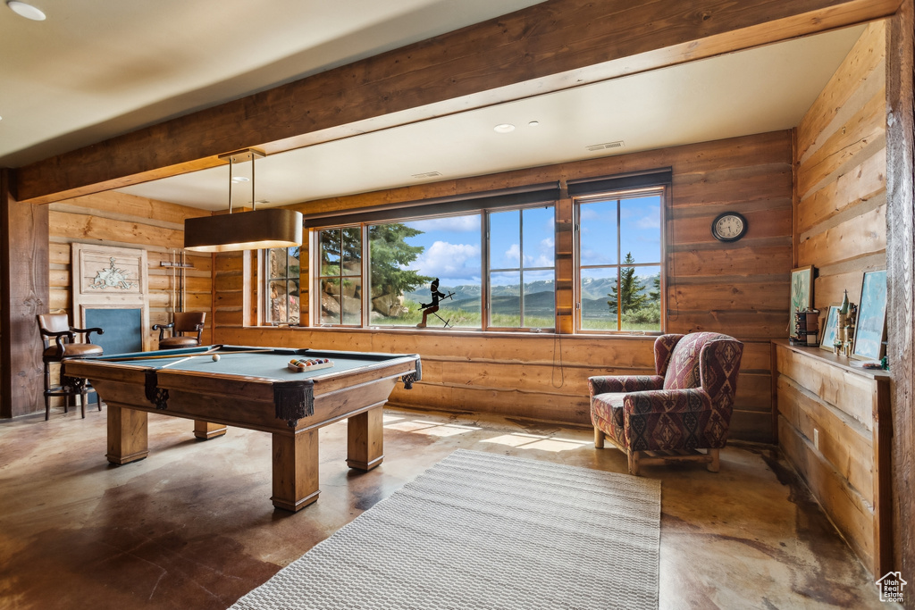 Recreation room with pool table, concrete floors, and wooden walls