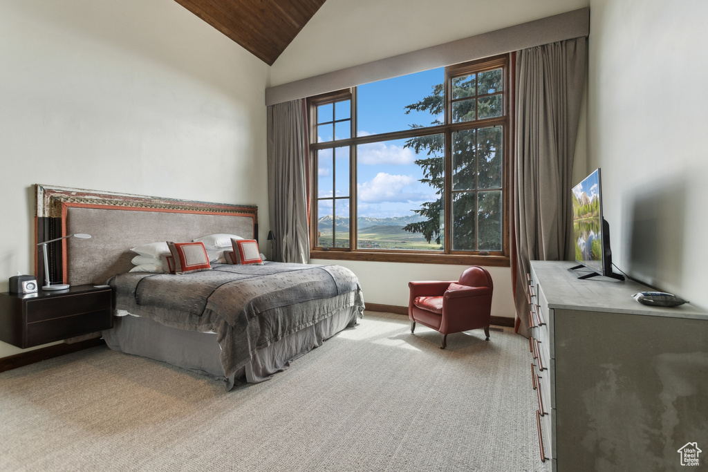 Carpeted bedroom with lofted ceiling, wooden ceiling, and baseboards