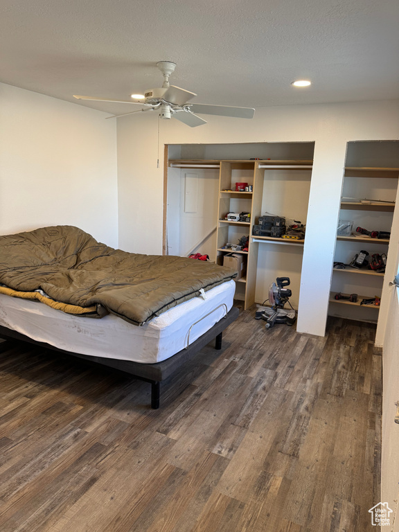 Bedroom with dark wood-style floors and ceiling fan