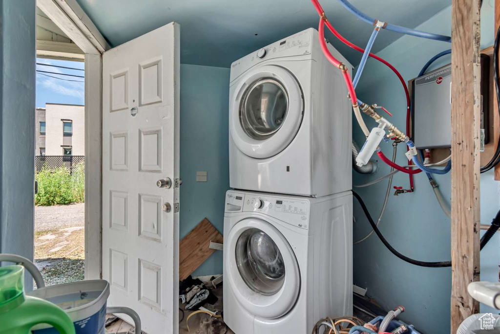 Laundry room with stacked washing machine and dryer