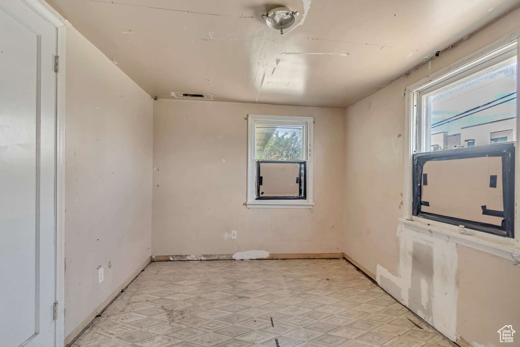 Empty room with baseboards and light flooring
