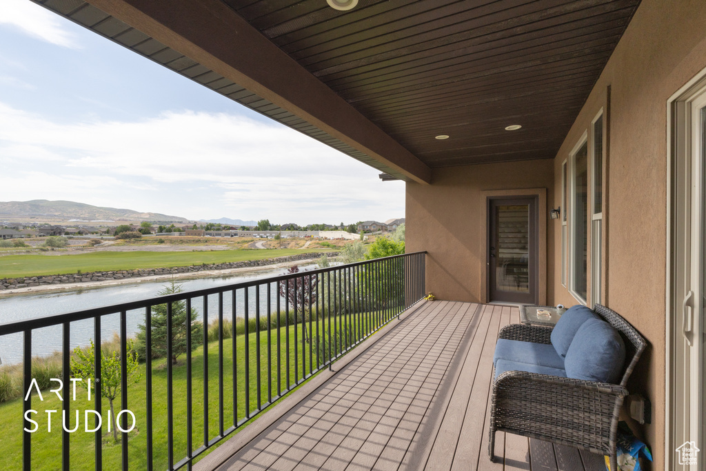 Balcony with a water and mountain view