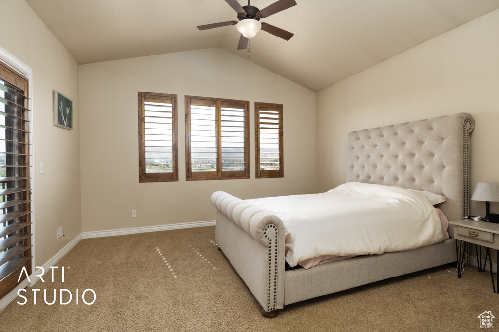 Bedroom featuring carpet flooring, vaulted ceiling, baseboards, and ceiling fan