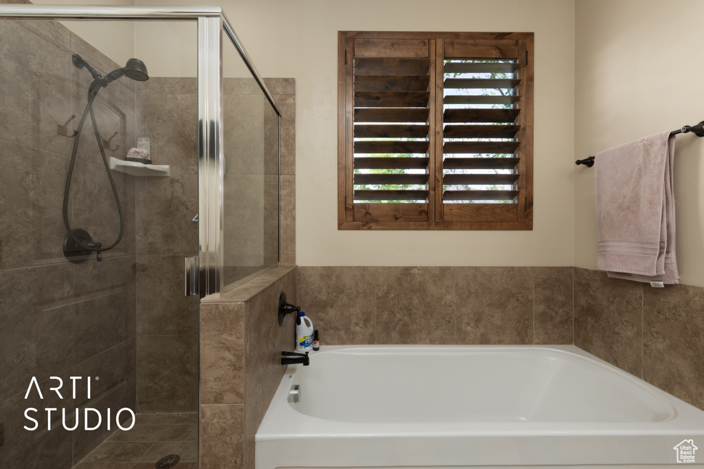 Bathroom with a shower stall and a garden tub