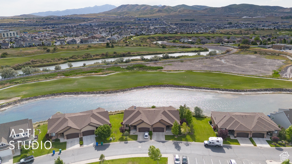 Aerial view of residential area featuring a water and mountain view and a local golf course