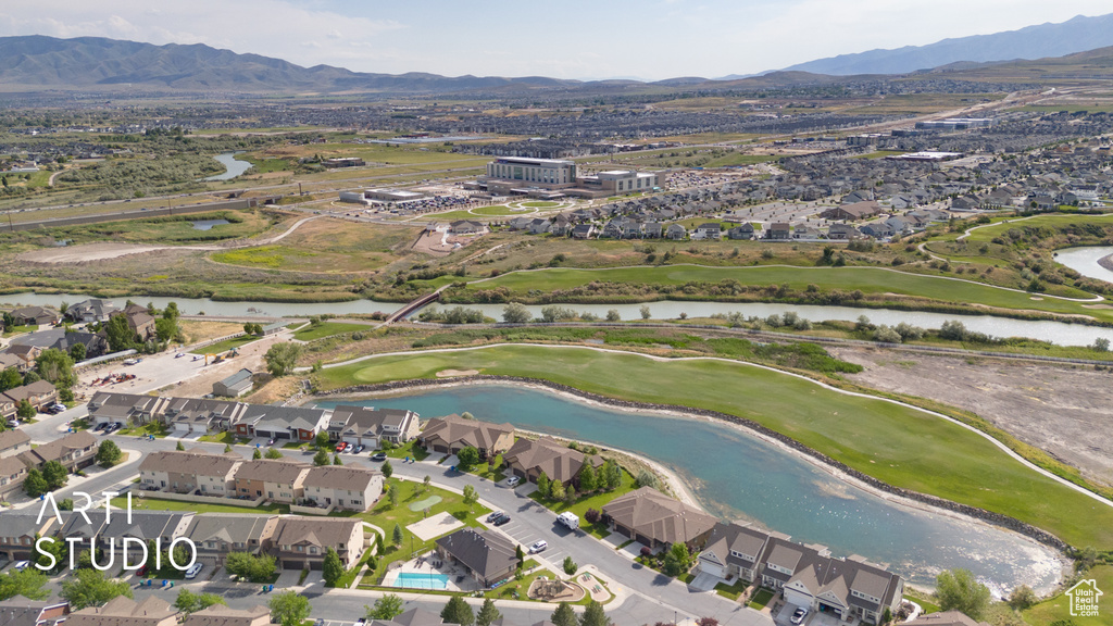 View of property location with a local golf course, nearby suburban area, and a water and mountain view