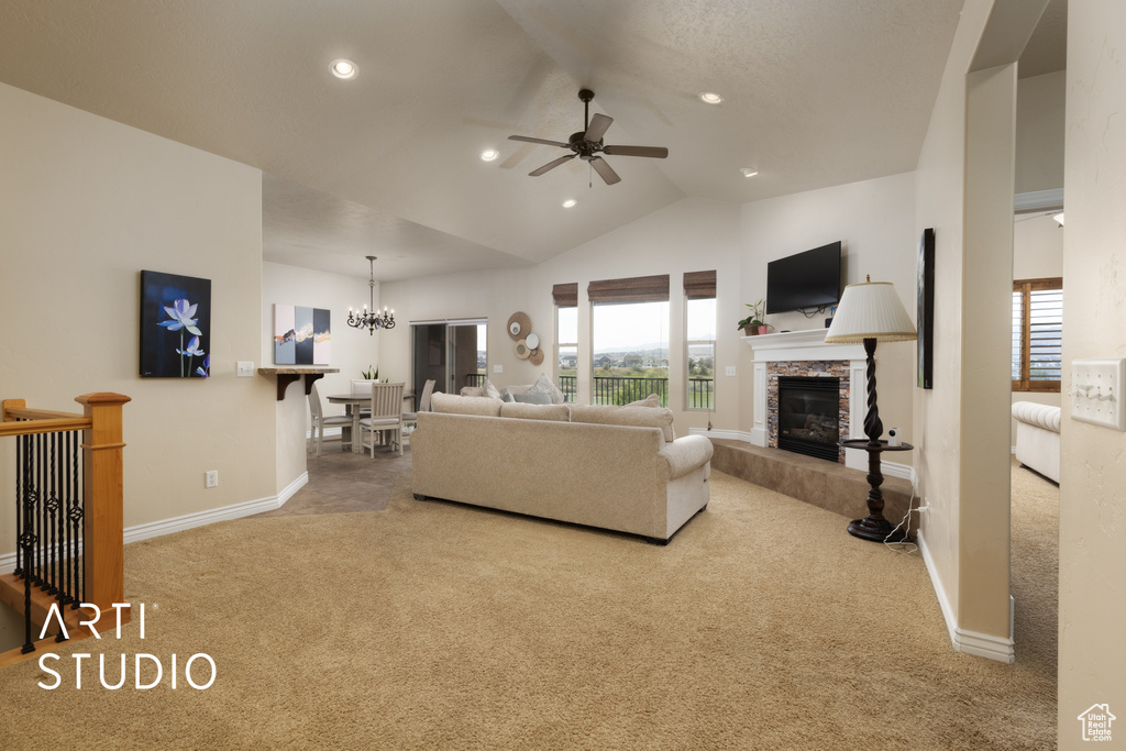 Living area with carpet flooring, ceiling fan, a chandelier, baseboards, and vaulted ceiling