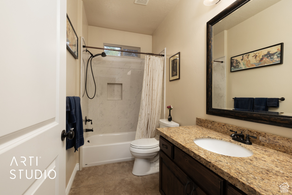 Bathroom with vanity, shower / bathtub combination with curtain, toilet, and tile patterned floors