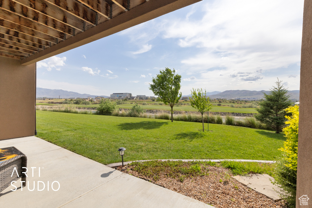 View of green lawn with a water and mountain view