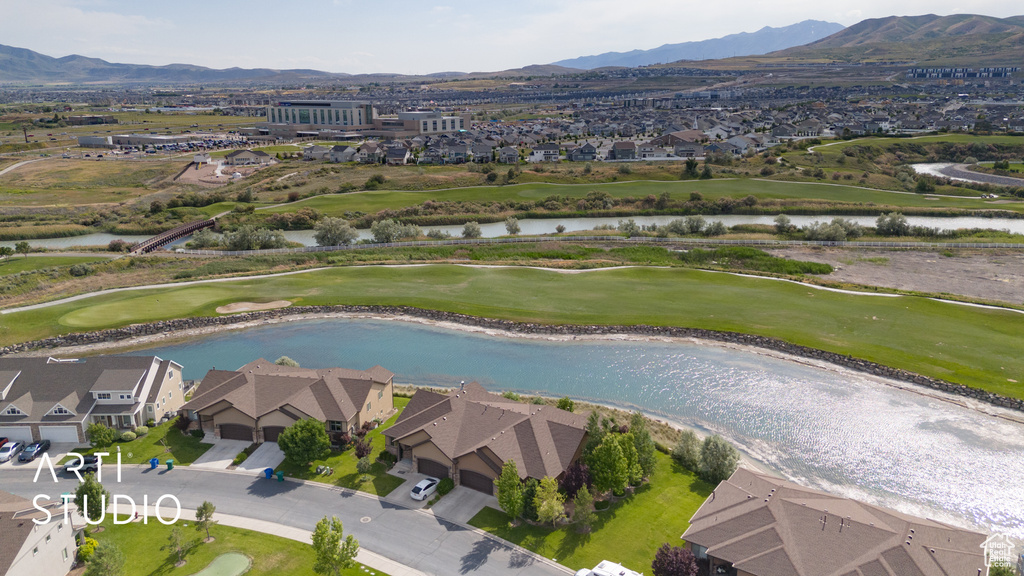 Aerial view of residential area featuring a water and mountain view and a golf club