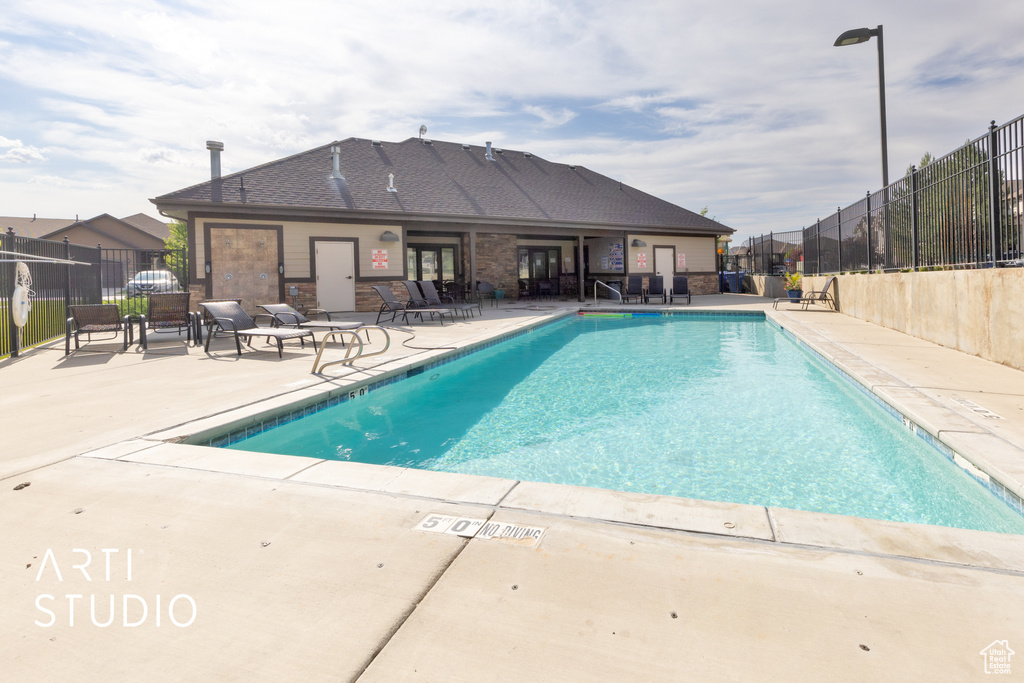 Community pool featuring a patio