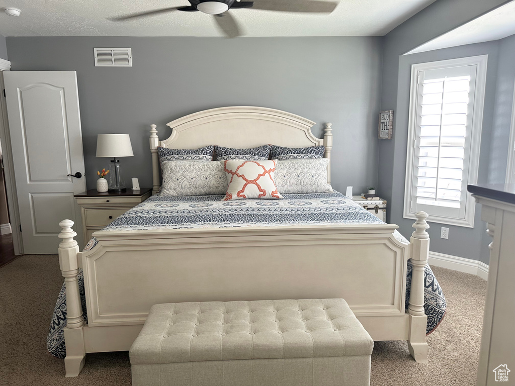 Bedroom with carpet floors, ceiling fan, and baseboards