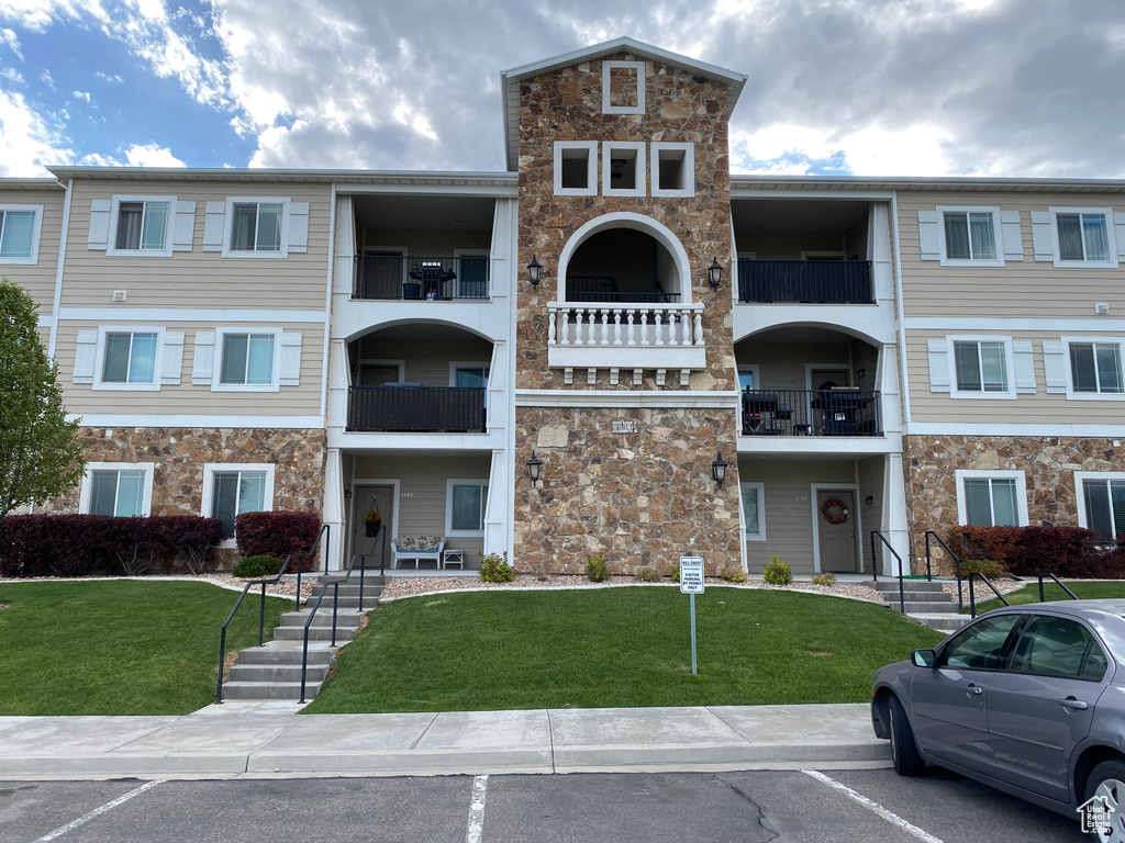 View of property with uncovered parking